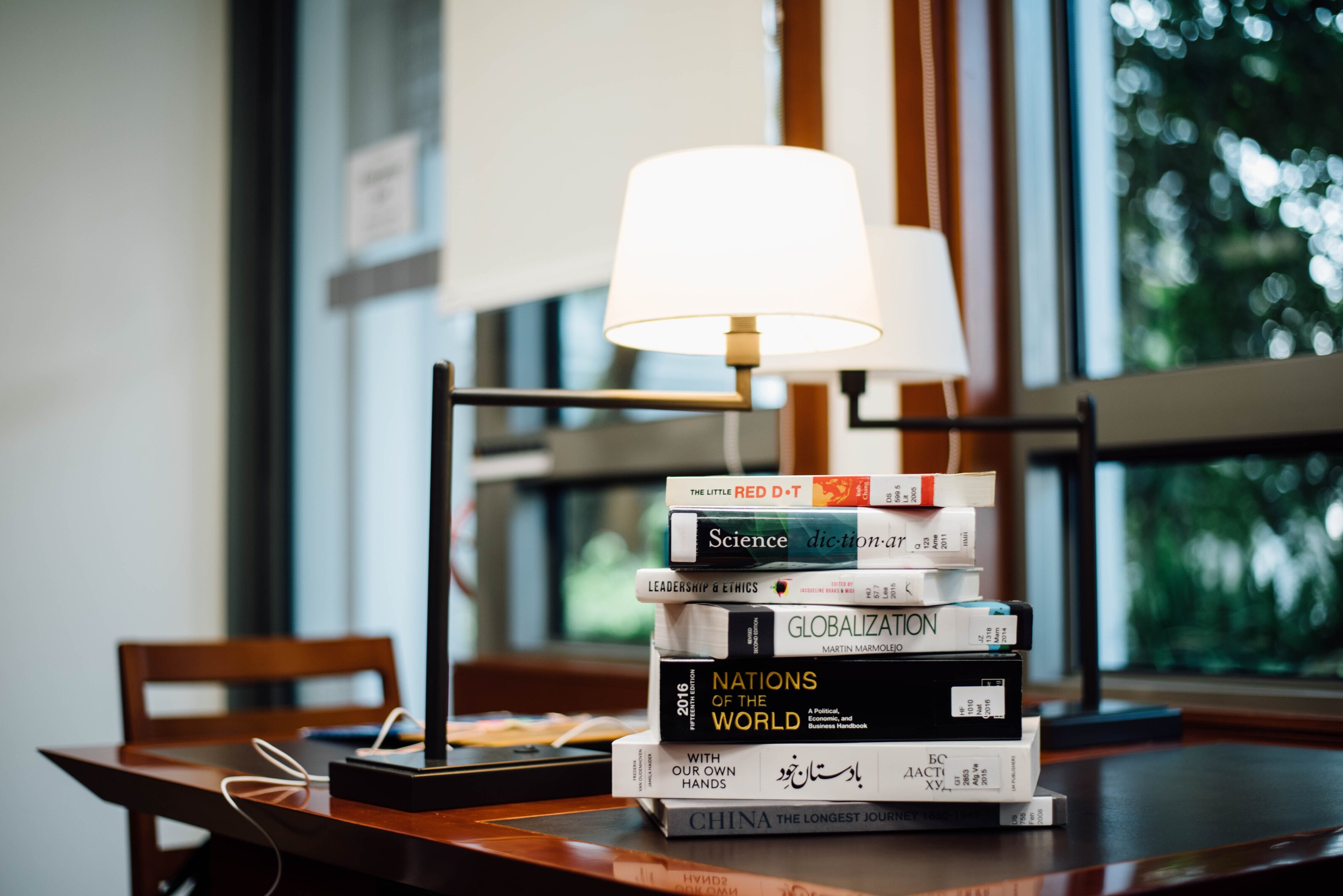 A stack of books by the window